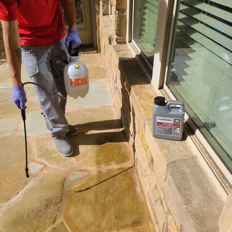 Stone sealing professional at work on Austin area property